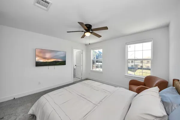 a bedroom with a bed and a chandelier
