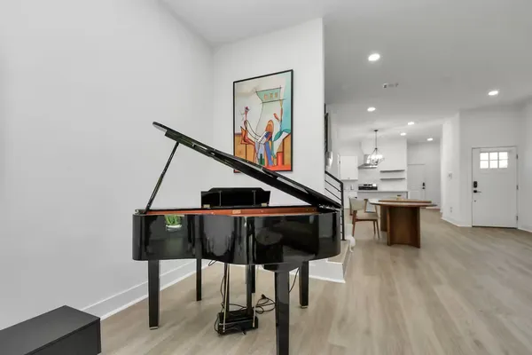 a living room with furniture and wooden floor