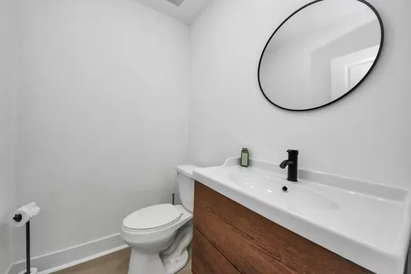 a bathroom with a sink a mirror and toilet
