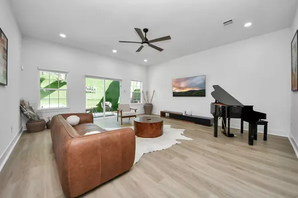 a living room with fireplace furniture and a wooden floor