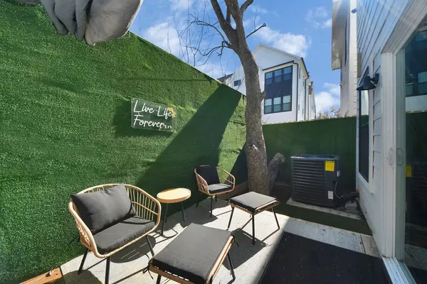a backyard of a house with table and chairs
