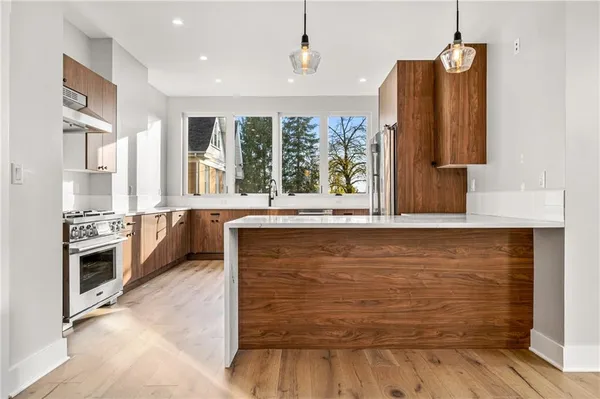 a view of a kitchen with wooden floor and electronic appliances