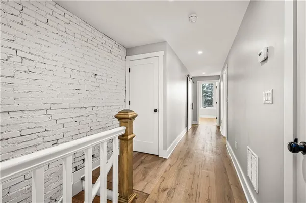 a view of a hallway with wooden floor