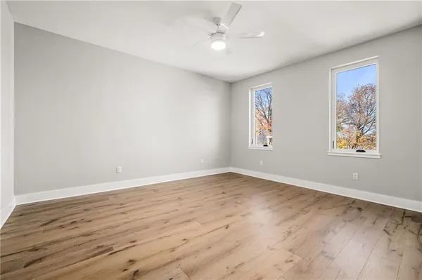 wooden floor in an empty room with a window