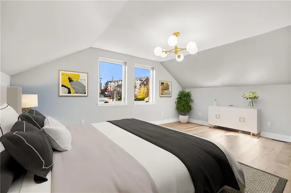 a bedroom with a bed and a chandelier