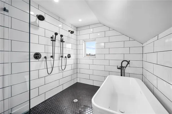 a bathroom with a bathtub and shower