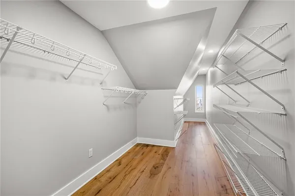 a view of a room with wooden floor