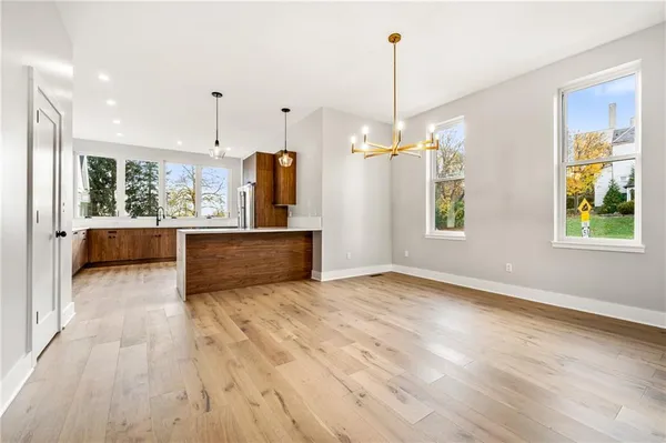 a view of a kitchen with wooden floor and a window