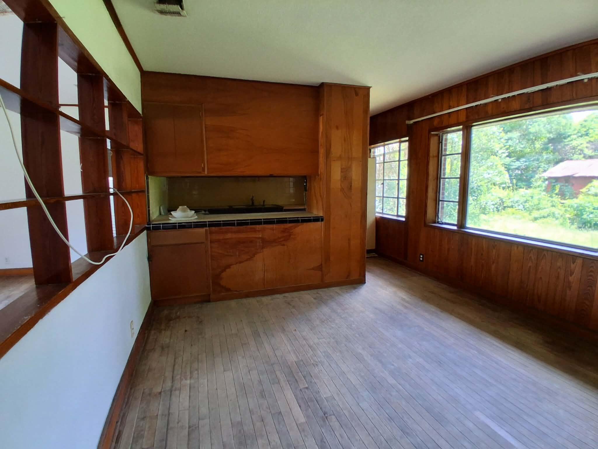 855 North Pearl Street Crestview, FL 32536 - Photo 6 of 31 a living room with stainless steel appliances wooden floors and a large window