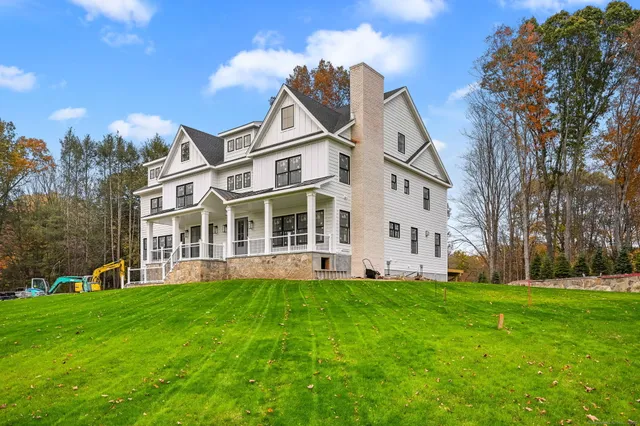 a view of a white house with a yard and plants