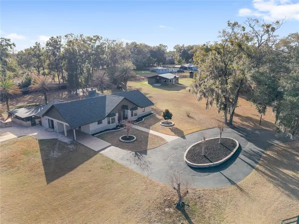 a view of a house with a tree in the background