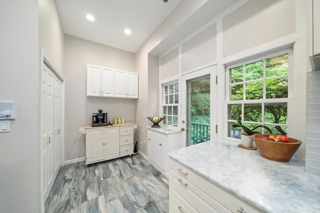 a room with a window and furniture