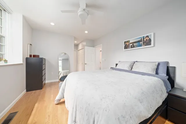 a spacious bedroom with a bed and a chandelier
