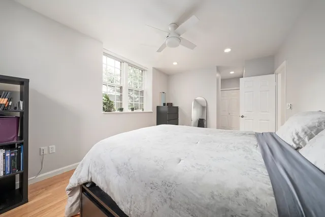 a spacious bedroom with a bed and a window