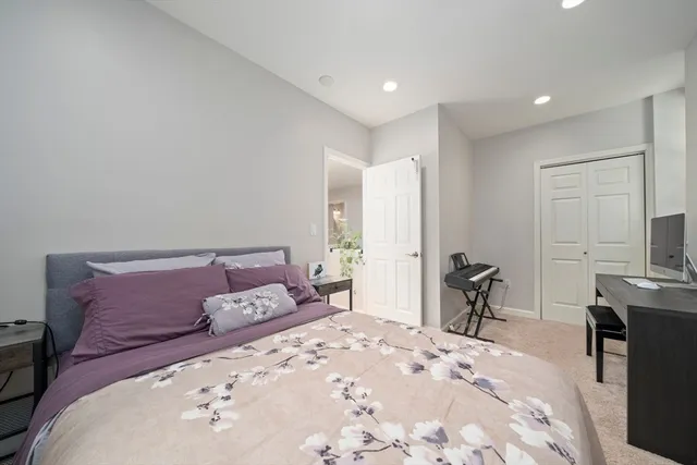 a bedroom with a large bed and a flat screen tv