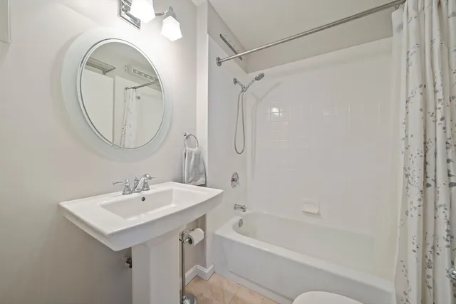 a bathroom with a sink a mirror and a bathtub