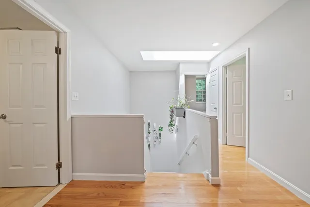 an empty room with wooden floor and entrance