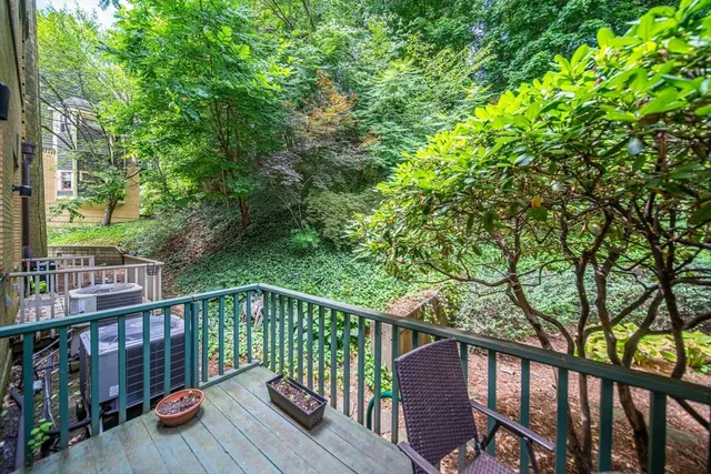 a view of city from a balcony with outdoor seating