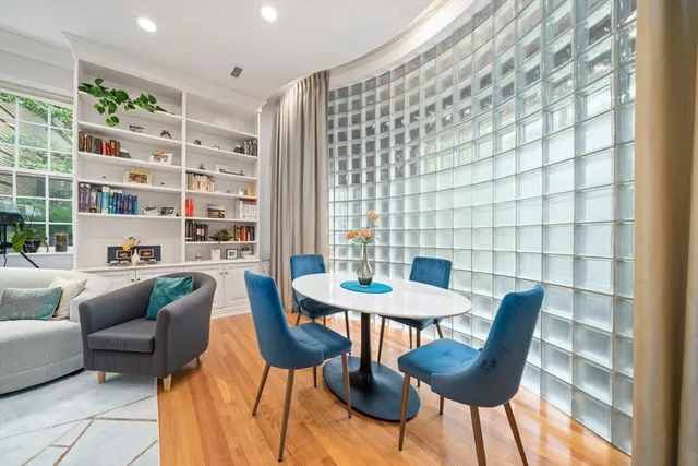 a view of a dining room with furniture and a potted plant