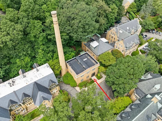 an aerial view of a house with a garden and trees