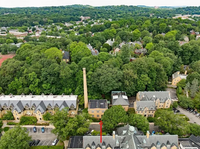 an aerial view of a house with a yard