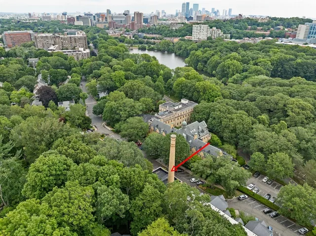 an aerial view of a houses with a lush green hillside