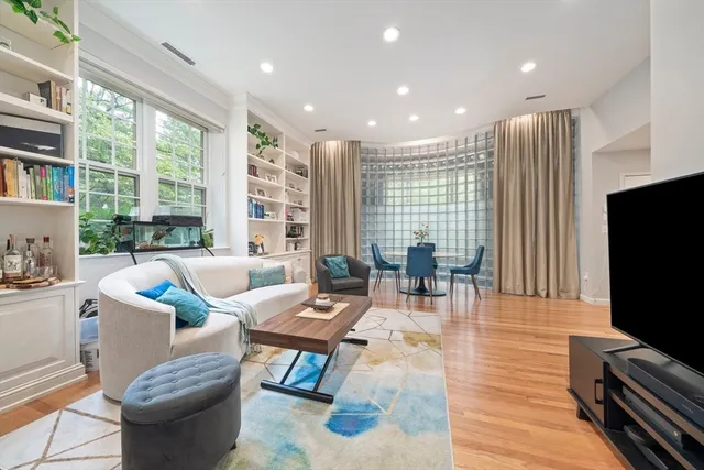 a living room with fireplace furniture and a flat screen tv