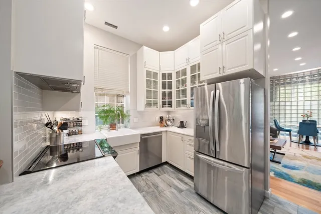 a kitchen with a refrigerator and a sink