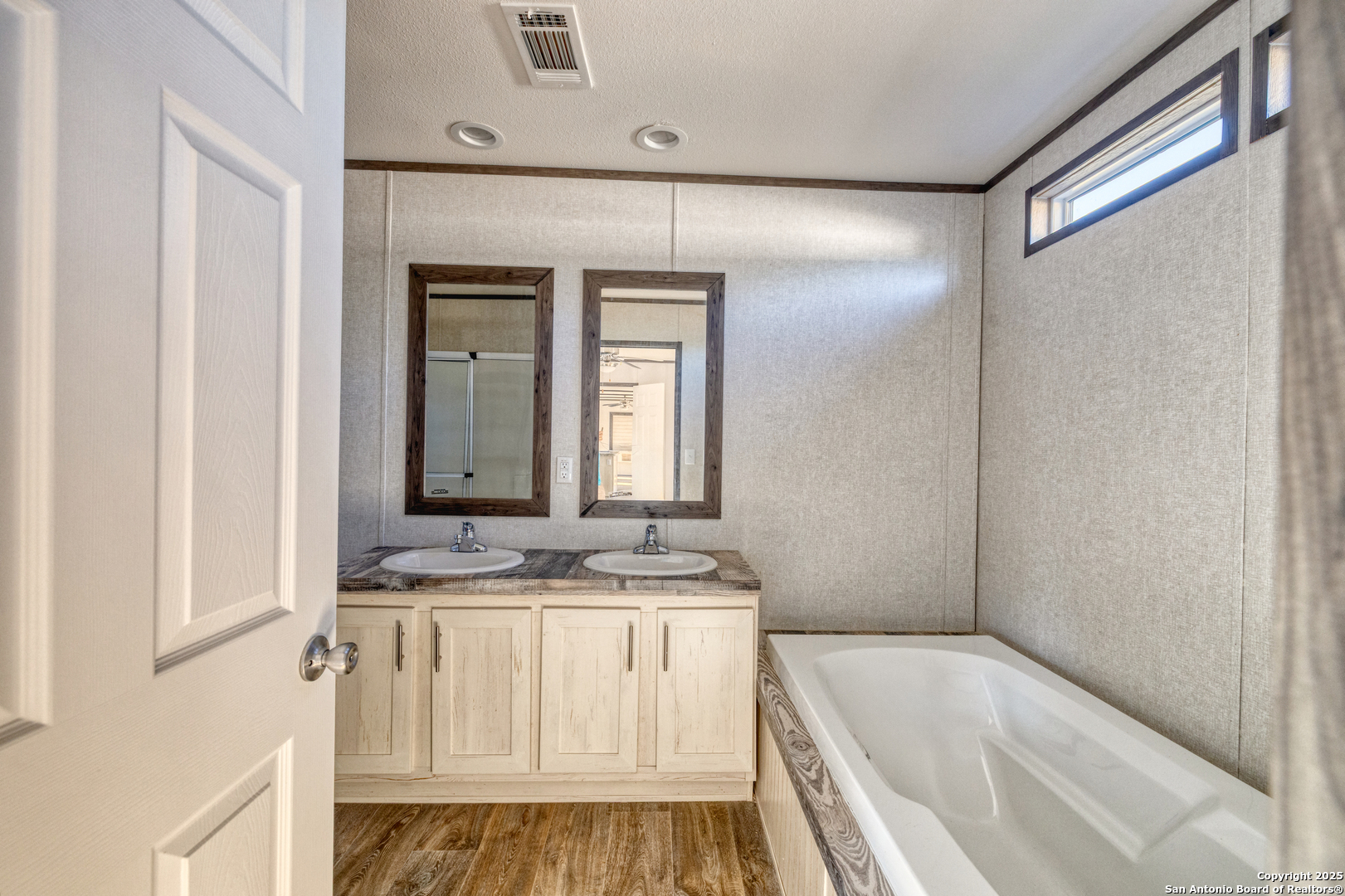 138 Senisa Drive Uvalde, TX 78801 - Photo 13 of 25 a bathroom with a granite countertop sink and a mirror