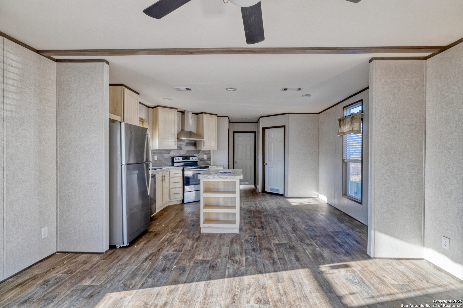 138 Senisa Drive Uvalde, TX 78801 - Photo 6 of 25 a kitchen with stainless steel appliances wooden floor and a refrigerator