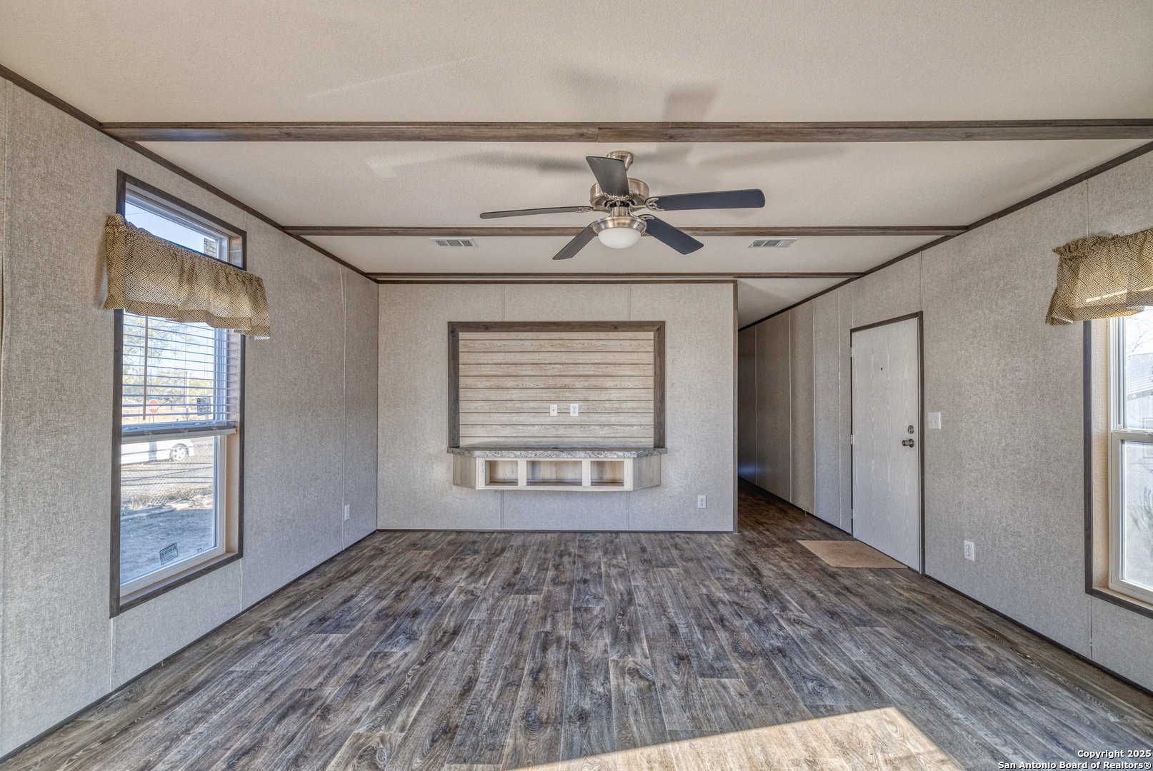 138 Senisa Drive Uvalde, TX 78801 - Photo 10 of 25 a view of an empty room with a window and wooden floor