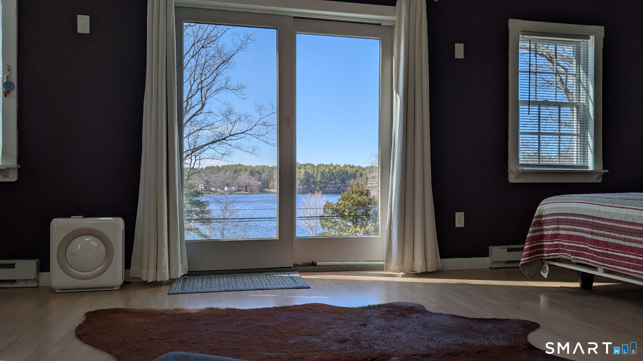 a bedroom with a bed and glass window