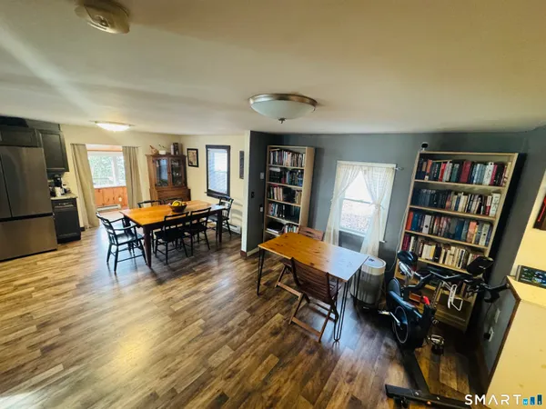 a bedroom with furniture and a large window