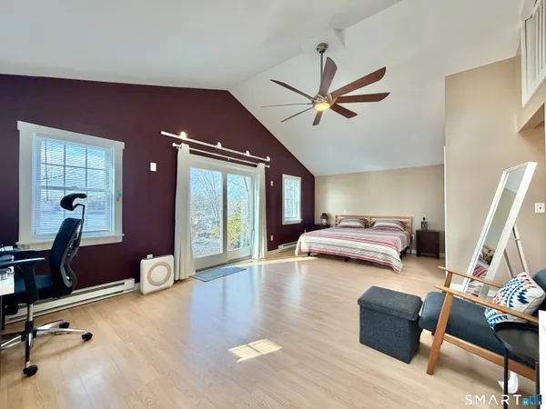 a living room with furniture gym equipment and a large window