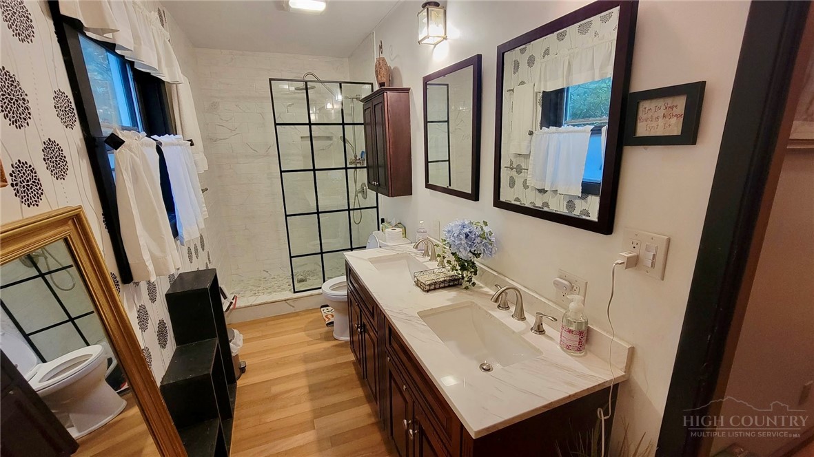 111 Locust Ridge Road Beech Mountain, NC 28604 - Photo 9 of 21 a bathroom with a sink a mirror and shower