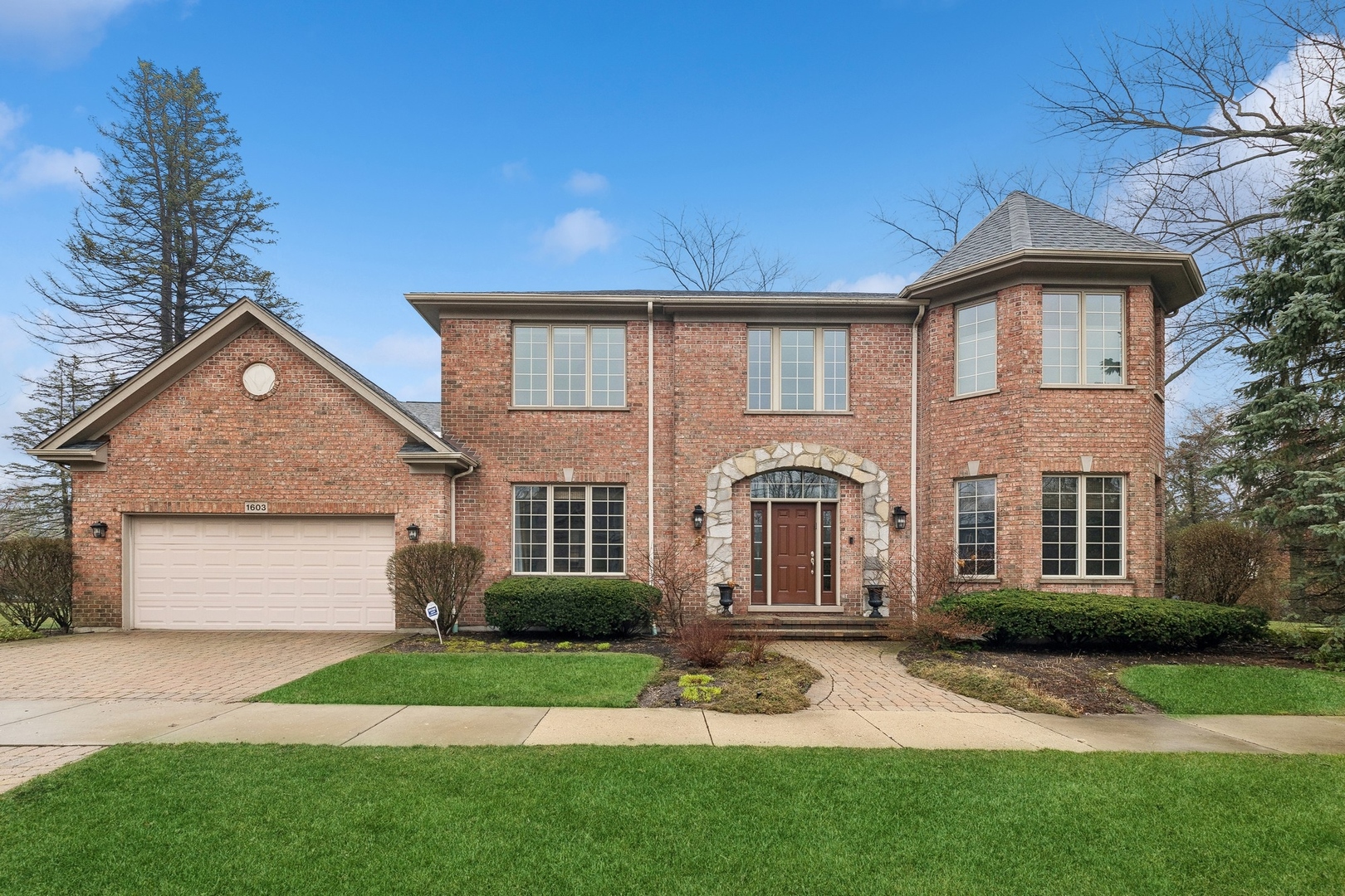a front view of a house with a yard and garage