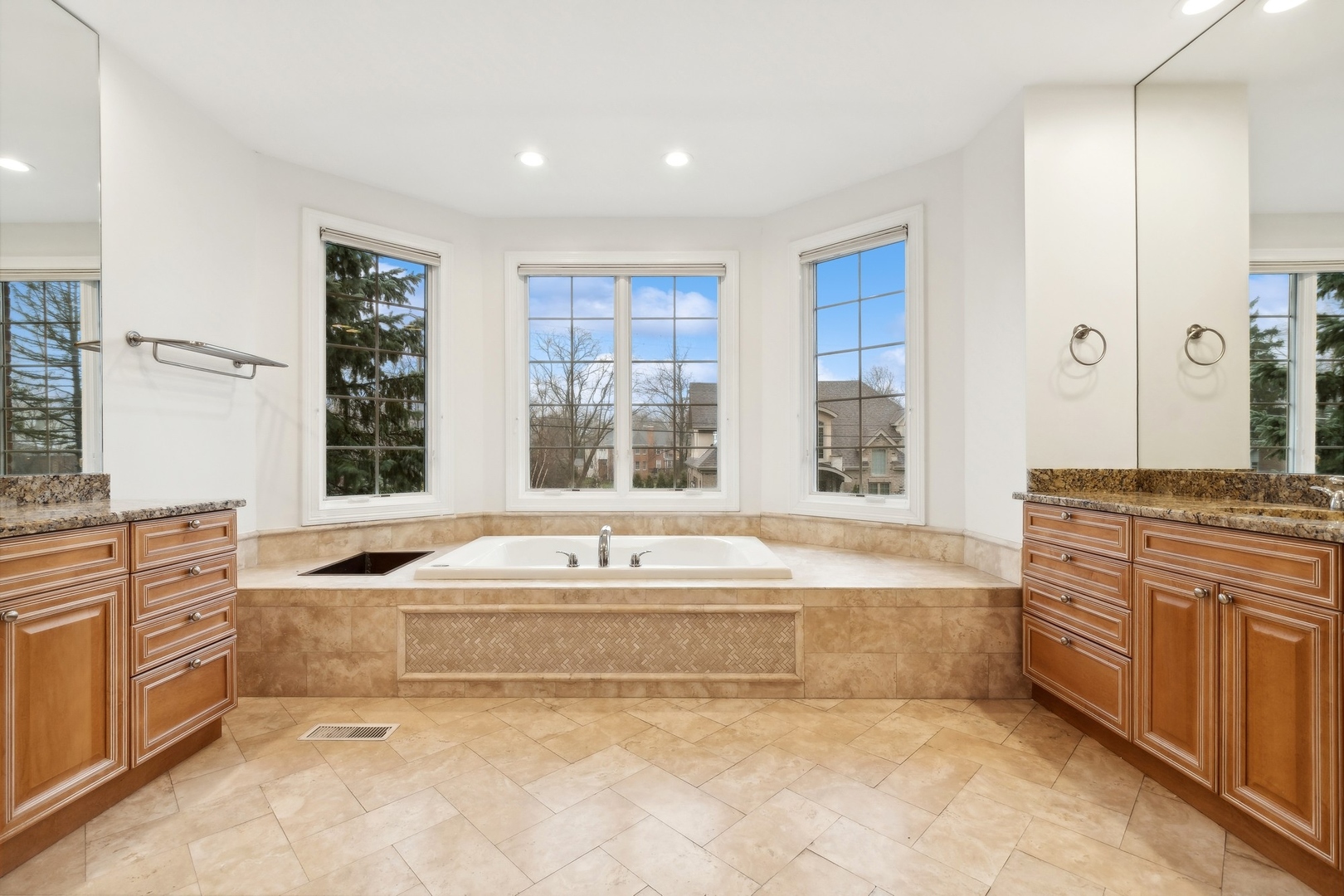 1603 Hertel Lane Deerfield, IL 60015 - Photo 21 of 27 a spacious bathroom with a granite countertop tub sink and mirror