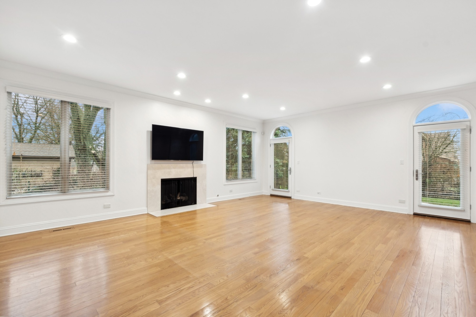 1603 Hertel Lane Deerfield, IL 60015 - Photo 7 of 27 an empty room with windows and fireplace