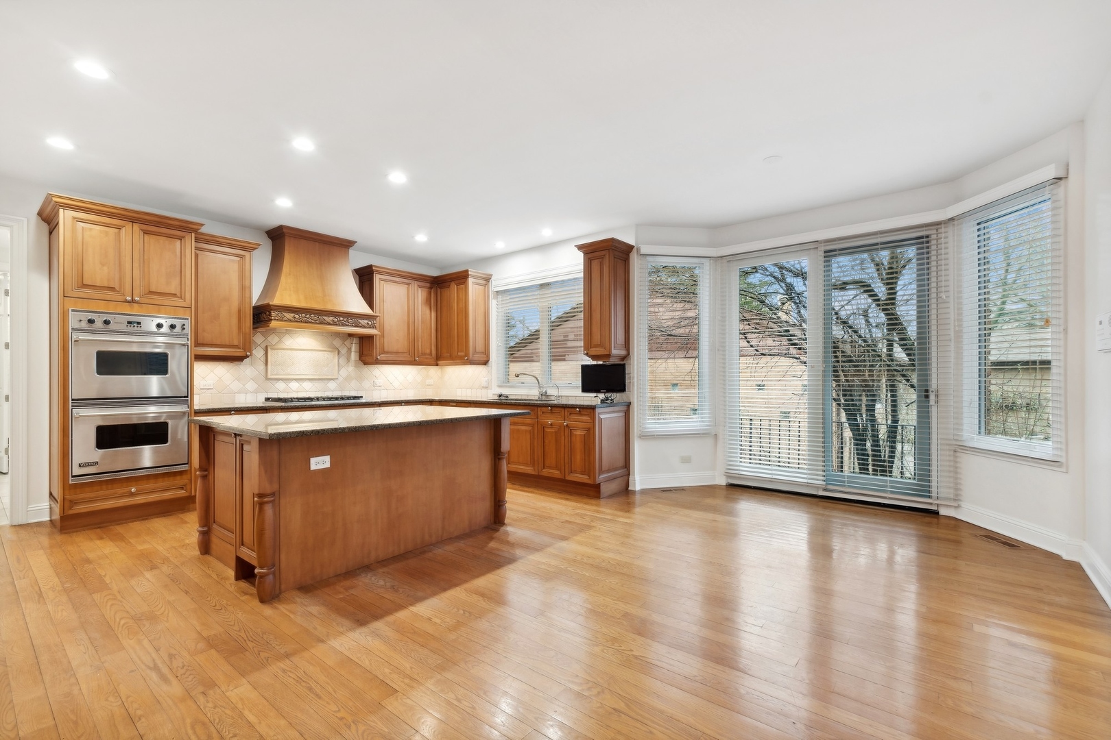 1603 Hertel Lane Deerfield, IL 60015 - Photo 9 of 27 a kitchen with stainless steel appliances granite countertop a stove top oven a sink and a refrigerator