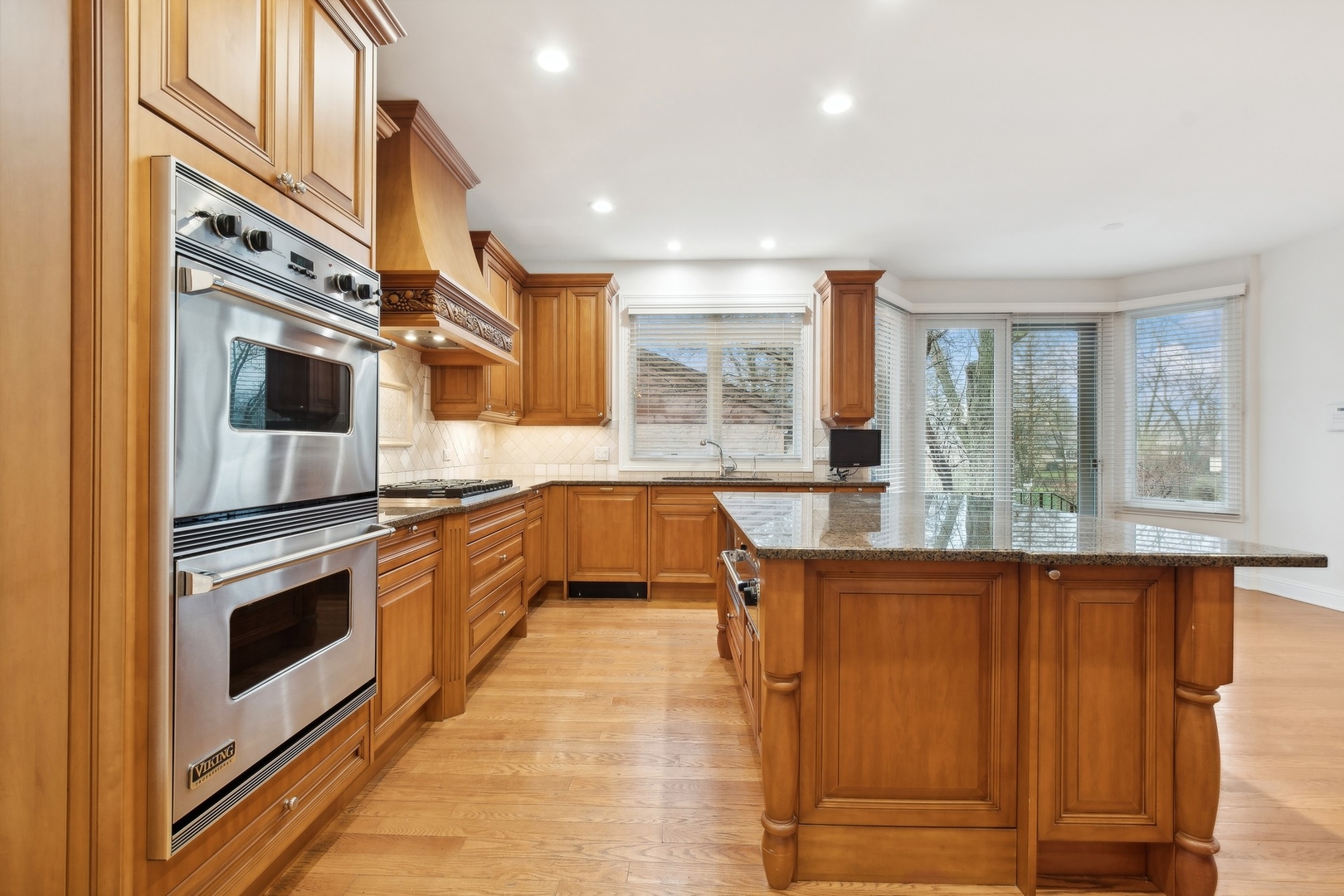 1603 Hertel Lane Deerfield, IL 60015 - Photo 10 of 27 a kitchen with stainless steel appliances granite countertop a stove and a refrigerator