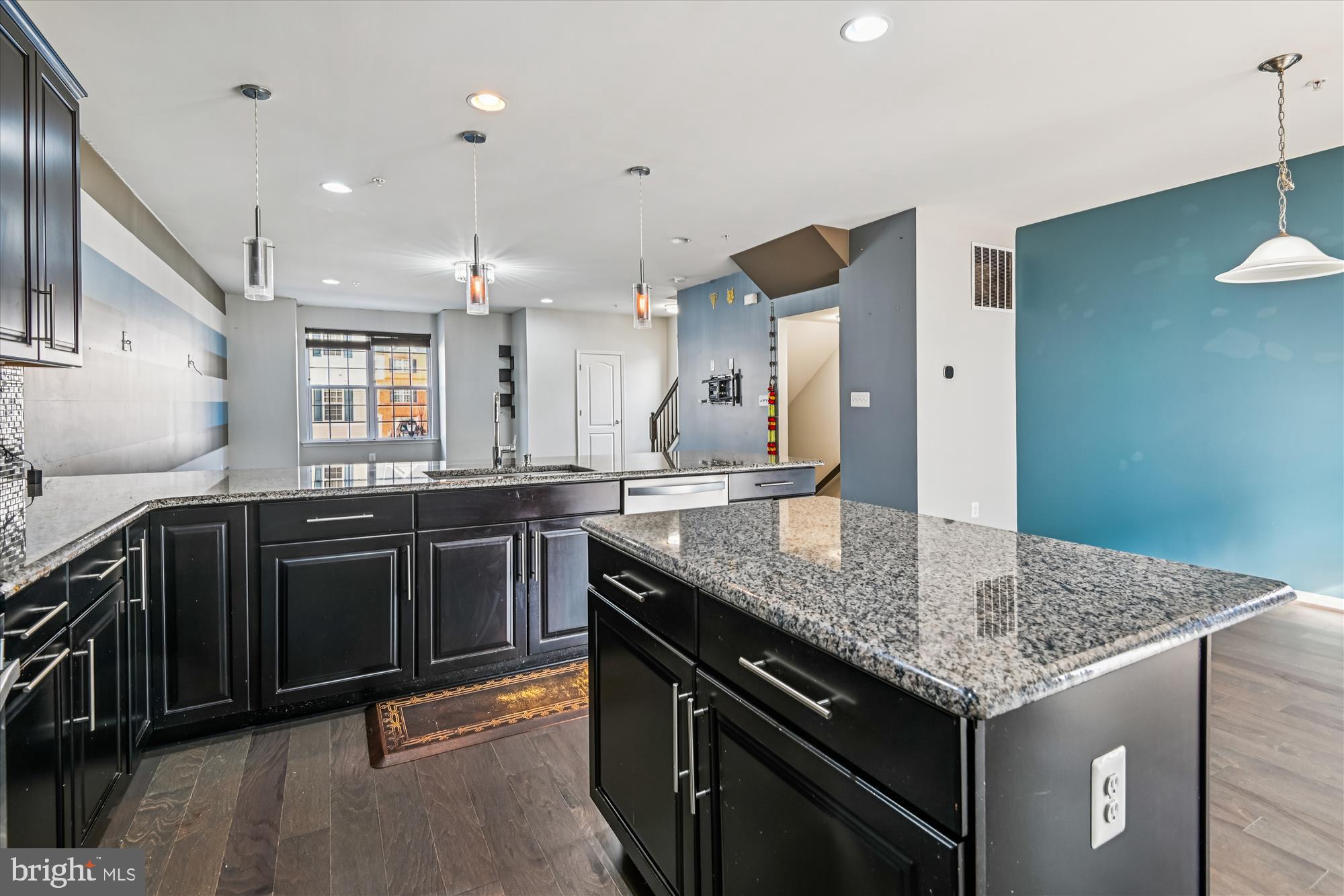 7749 Dagny Way Elkridge, MD 21075 - Photo 12 of 33 a kitchen with granite countertop kitchen island stainless steel appliances a sink stove and cabinets
