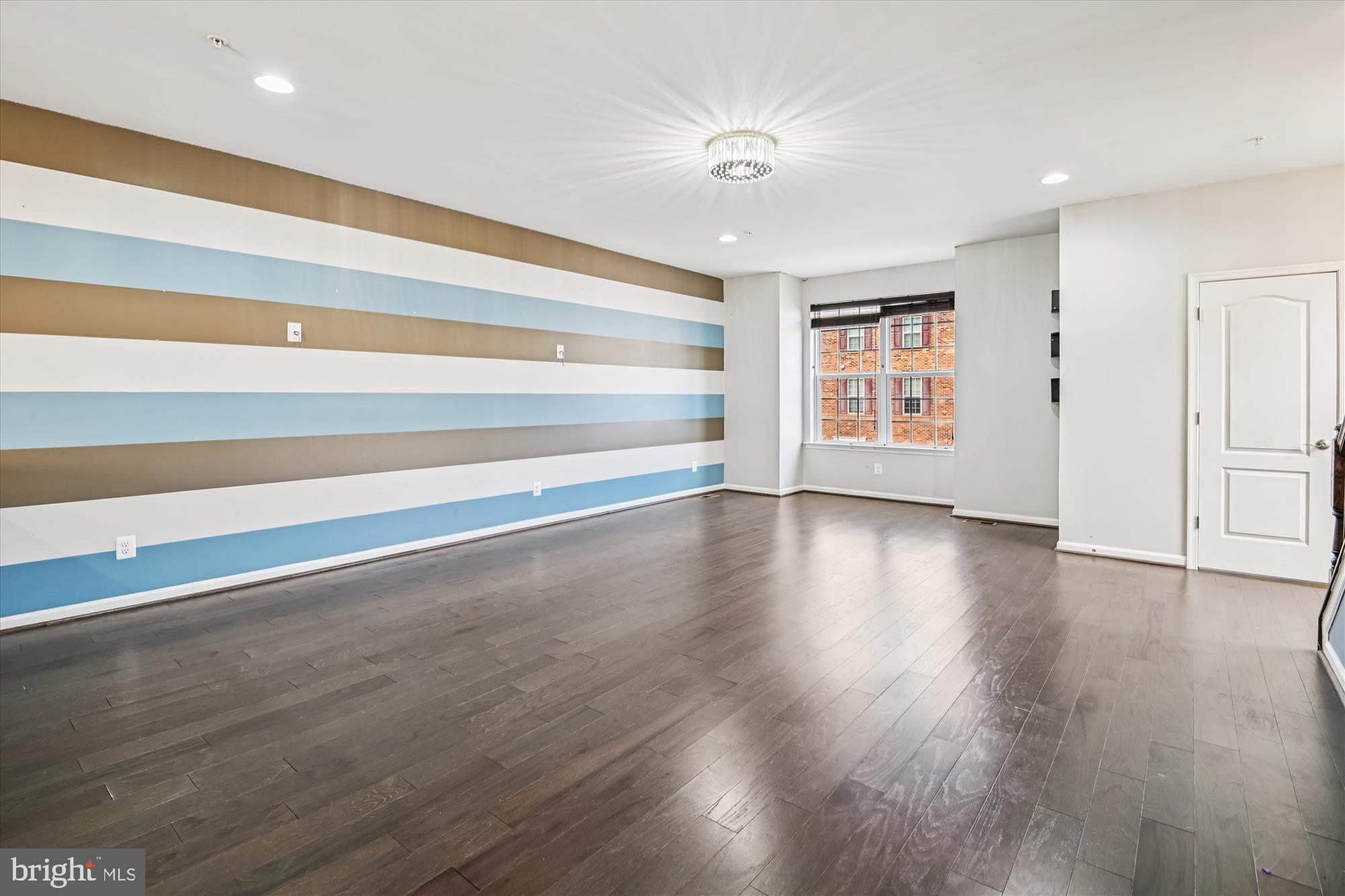 7749 Dagny Way Elkridge, MD 21075 - Photo 7 of 33 a view of an empty room with wooden floor and a window