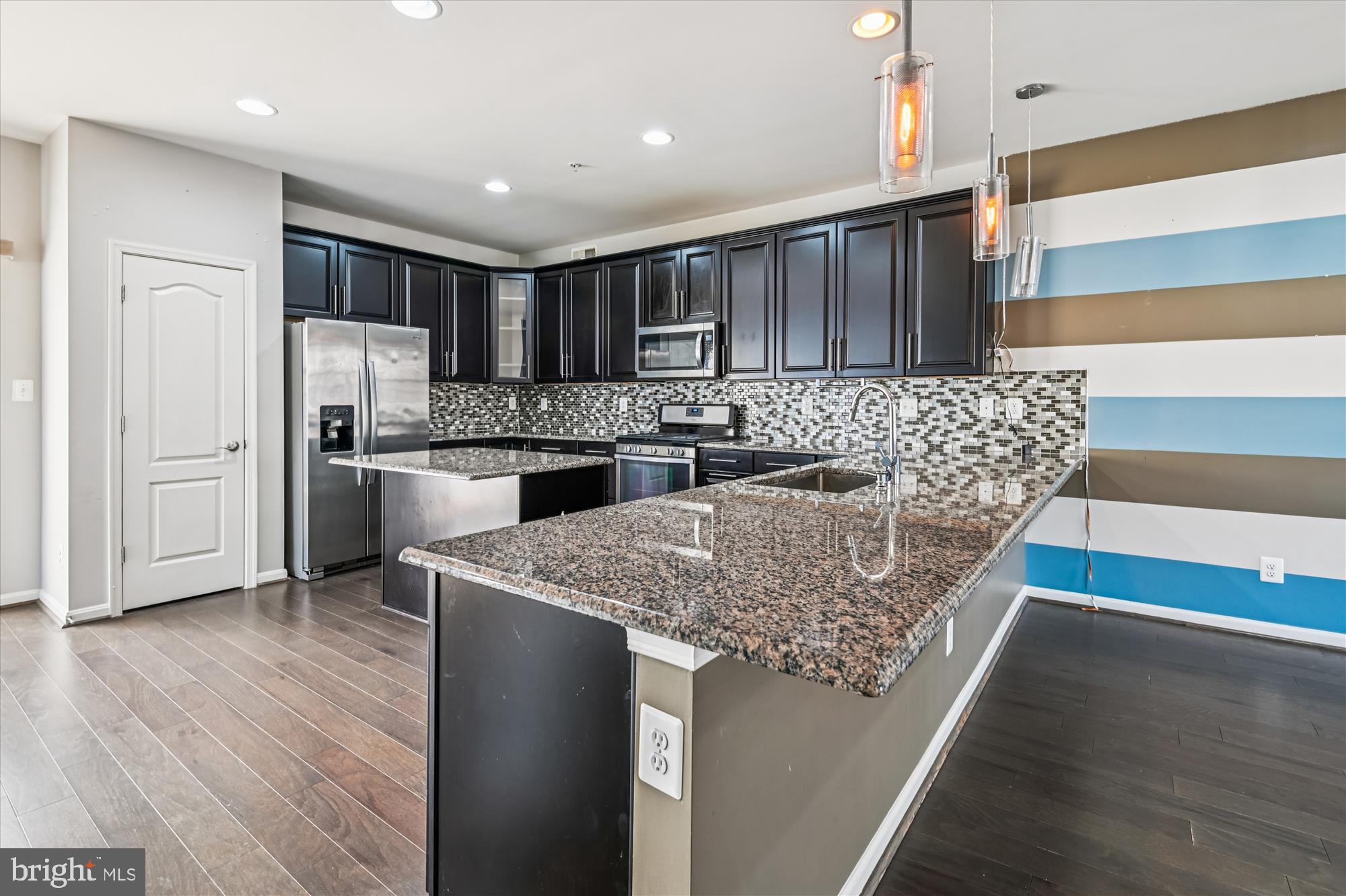 7749 Dagny Way Elkridge, MD 21075 - Photo 9 of 33 a kitchen with stainless steel appliances granite countertop a sink stove and refrigerator