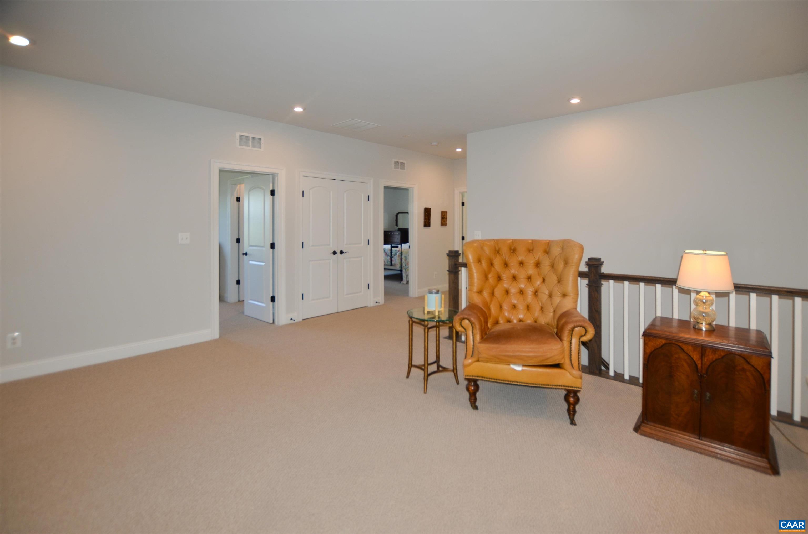 327 Claibourne Road Crozet, VA 22932 - Photo 28 of 36 a bedroom with a bed and a chair