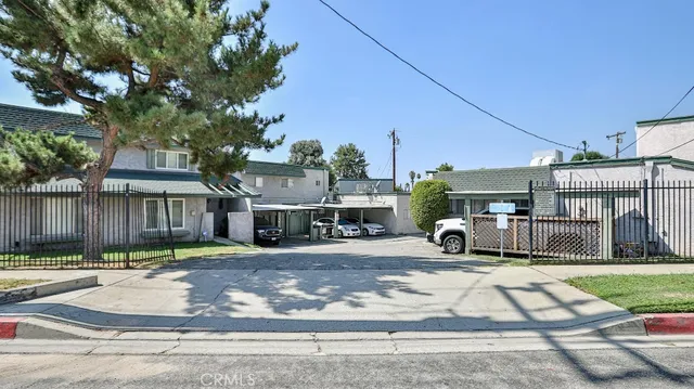 a view of a town with brick building and large tree