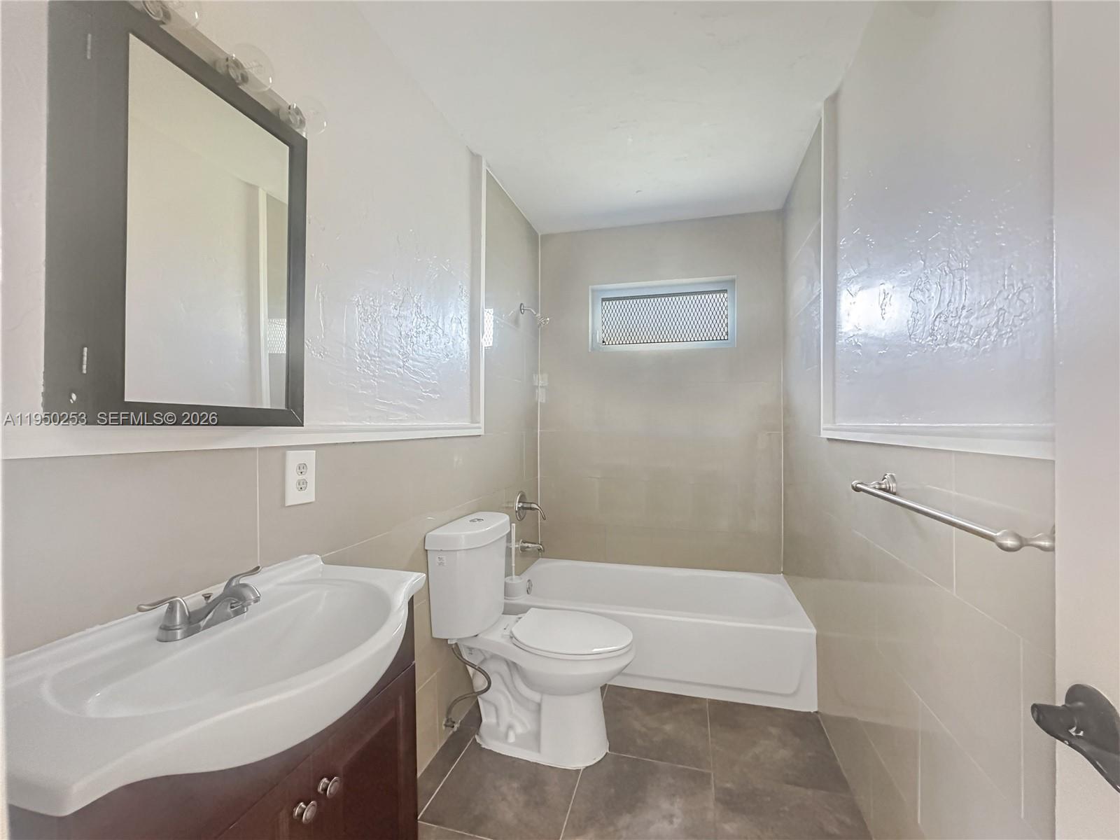11330 Southwest 207th Drive, Unit LEFT Miami, FL 33189 - Photo 7 of 10 a bathroom with a sink toilet and shower