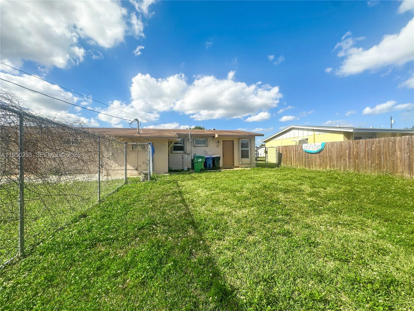 11330 Southwest 207th Drive, Unit LEFT Miami, FL 33189 - Photo 10 of 10 a view of a house with a backyard