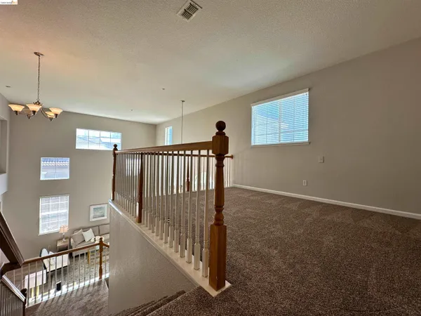 a view of a livingroom with furniture and staircase