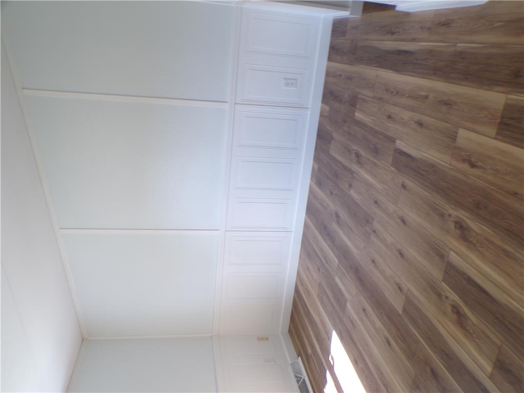 7877 Gun Club Road New Tripoli, PA 18066 - Photo 12 of 19 Laminate flooring and wall paneling create a refined interior setting.