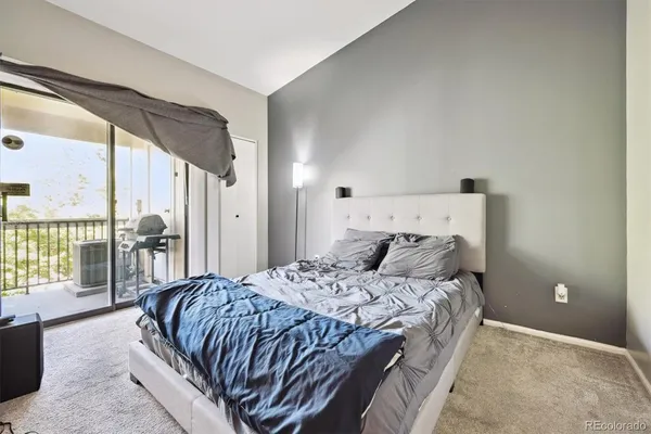 a bedroom with a large bed and a large window